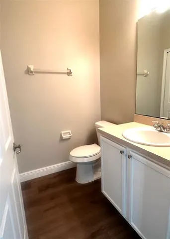 a bathroom with a toilet a sink and a mirror