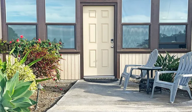 a view of a porch with a table and chairs and potted plants