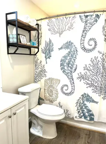 a white toilet sitting next to a bathroom sink