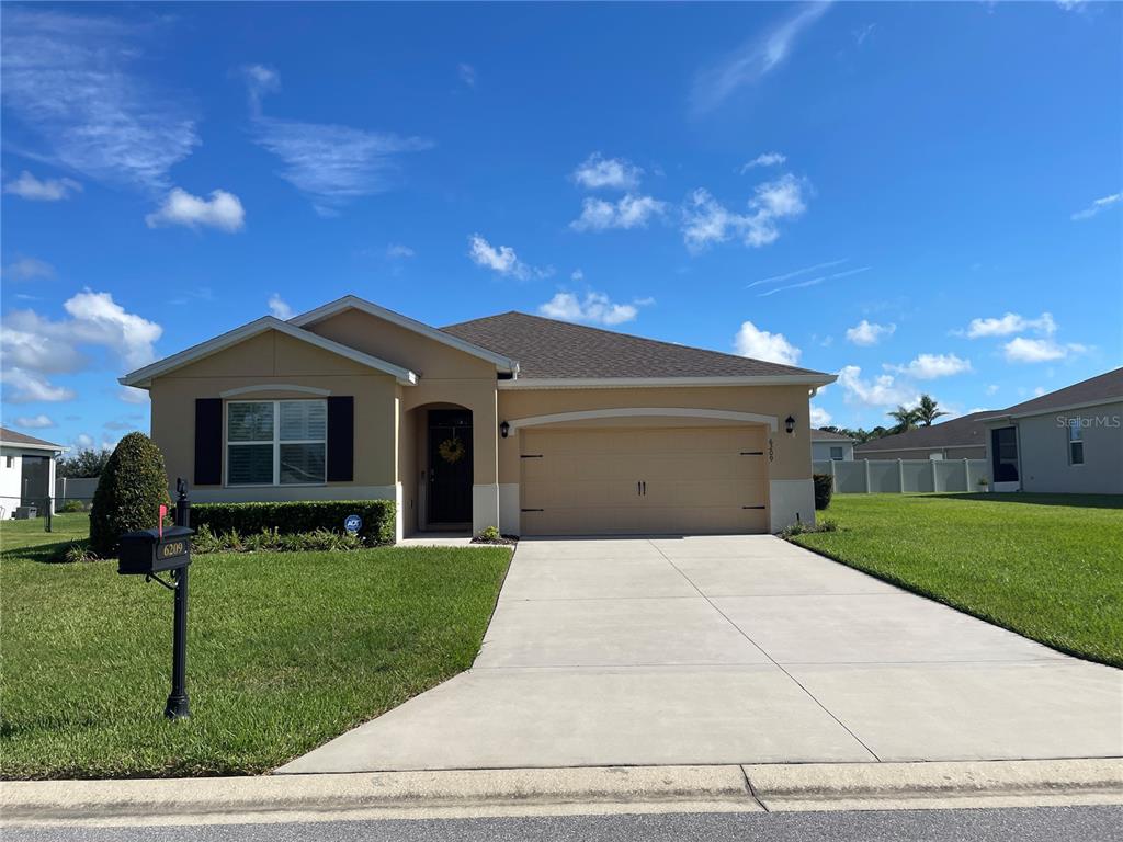 6209 Southwest 89th St Road Ocala, FL 34476 - Photo 1 of 27 a front view of a house with a yard and garage