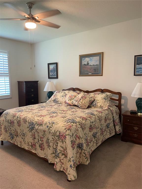 6209 Southwest 89th St Road Ocala, FL 34476 - Photo 18 of 27 a bedroom with a bed and a lamp on dresser