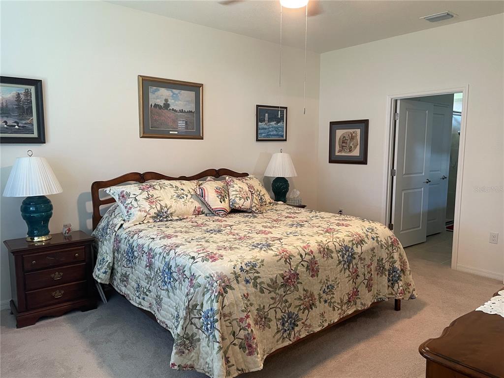 6209 Southwest 89th St Road Ocala, FL 34476 - Photo 19 of 27 a bedroom with a bed and wall painting