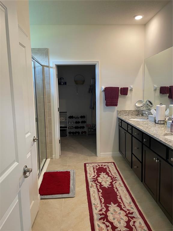 6209 Southwest 89th St Road Ocala, FL 34476 - Photo 20 of 27 a bedroom with a bed and a lamp on dresser