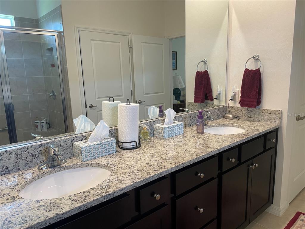 6209 Southwest 89th St Road Ocala, FL 34476 - Photo 22 of 27 a bathroom with double vanity sinks and a mirror