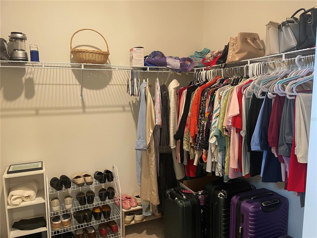 6209 Southwest 89th St Road Ocala, FL 34476 - Photo 23 of 27 a view of walk in closet with clothes and shoes