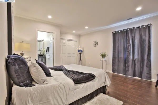 a bedroom with a bed and a mirror