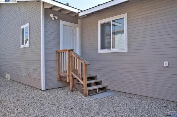 a view of a patio with wooden floor and fence