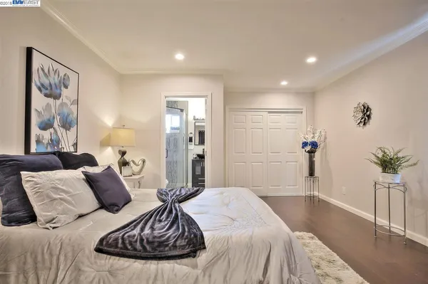 a spacious bedroom with a bed and a couch