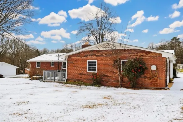 a view of a house with a snow in the yard