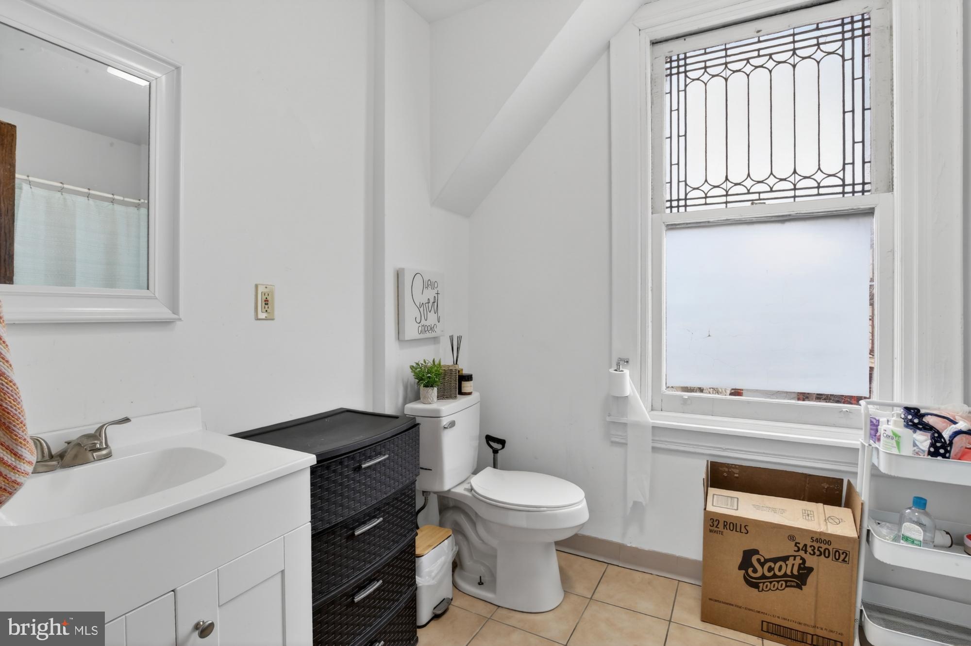 4001 Baltimore Avenue Philadelphia, PA 19104 - Photo 18 of 40 a bathroom with a granite countertop toilet sink and mirror