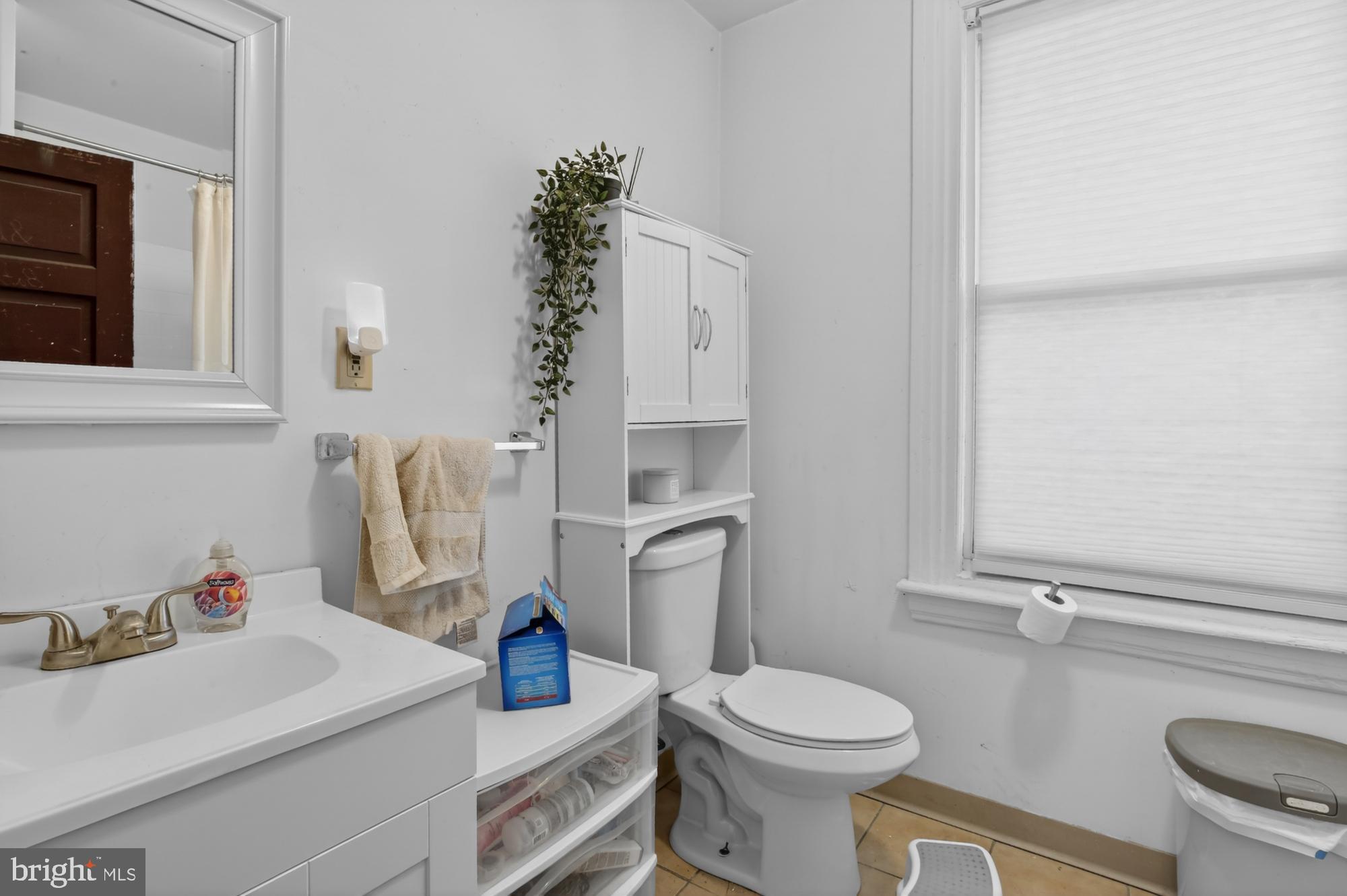 4001 Baltimore Avenue Philadelphia, PA 19104 - Photo 27 of 40 a bathroom with a sink toilet and a mirror