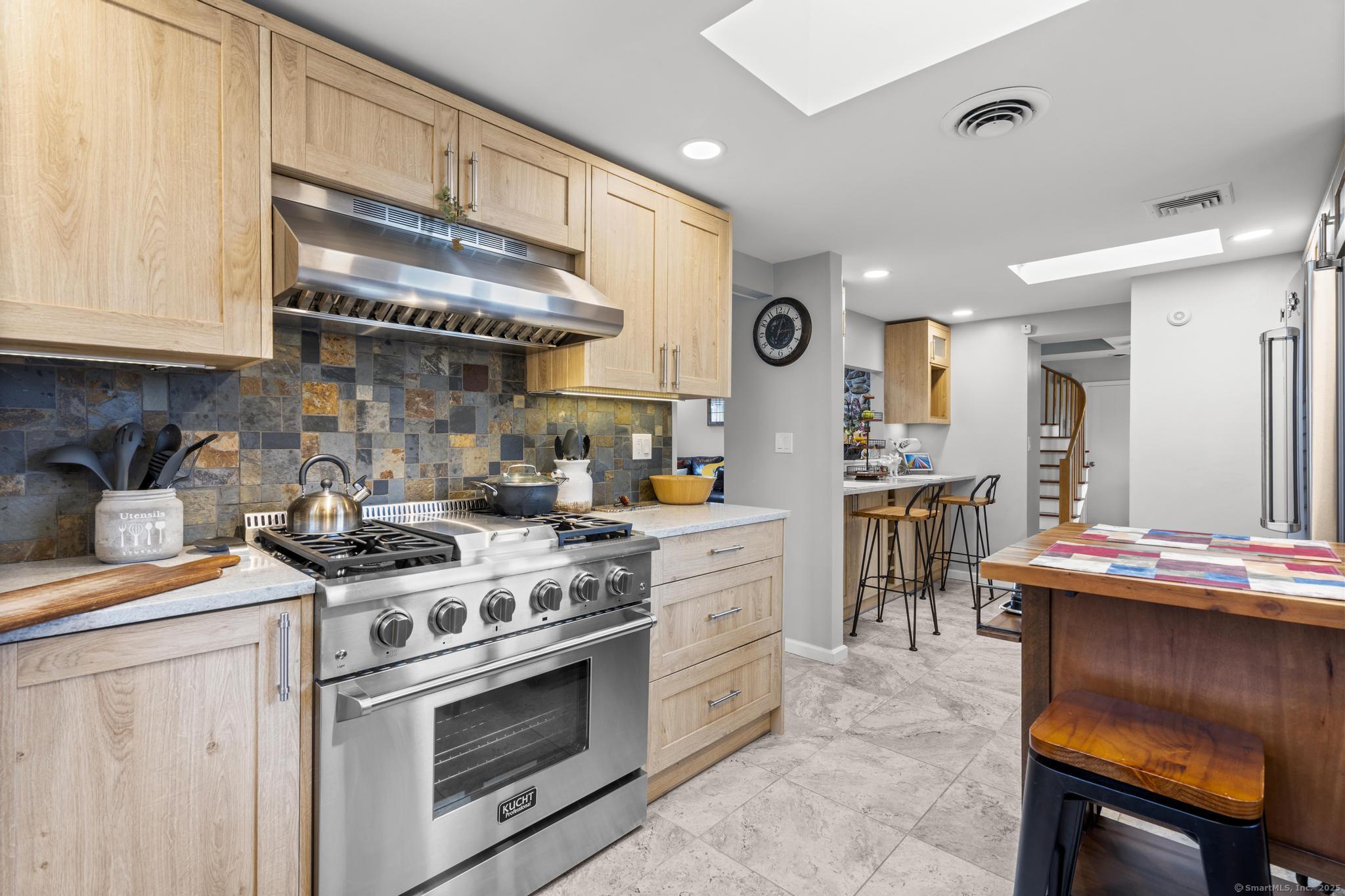 94 Summer Island Road Branford, CT 06405 - Photo 11 of 40 a kitchen with stainless steel appliances granite countertop a stove a sink and a refrigerator