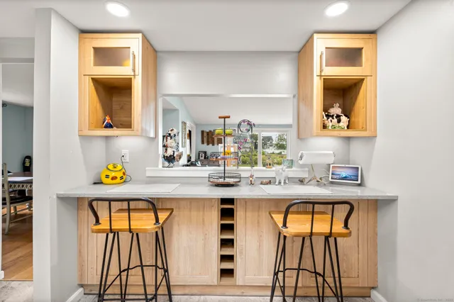 a kitchen with stainless steel appliances granite countertop a sink and a window