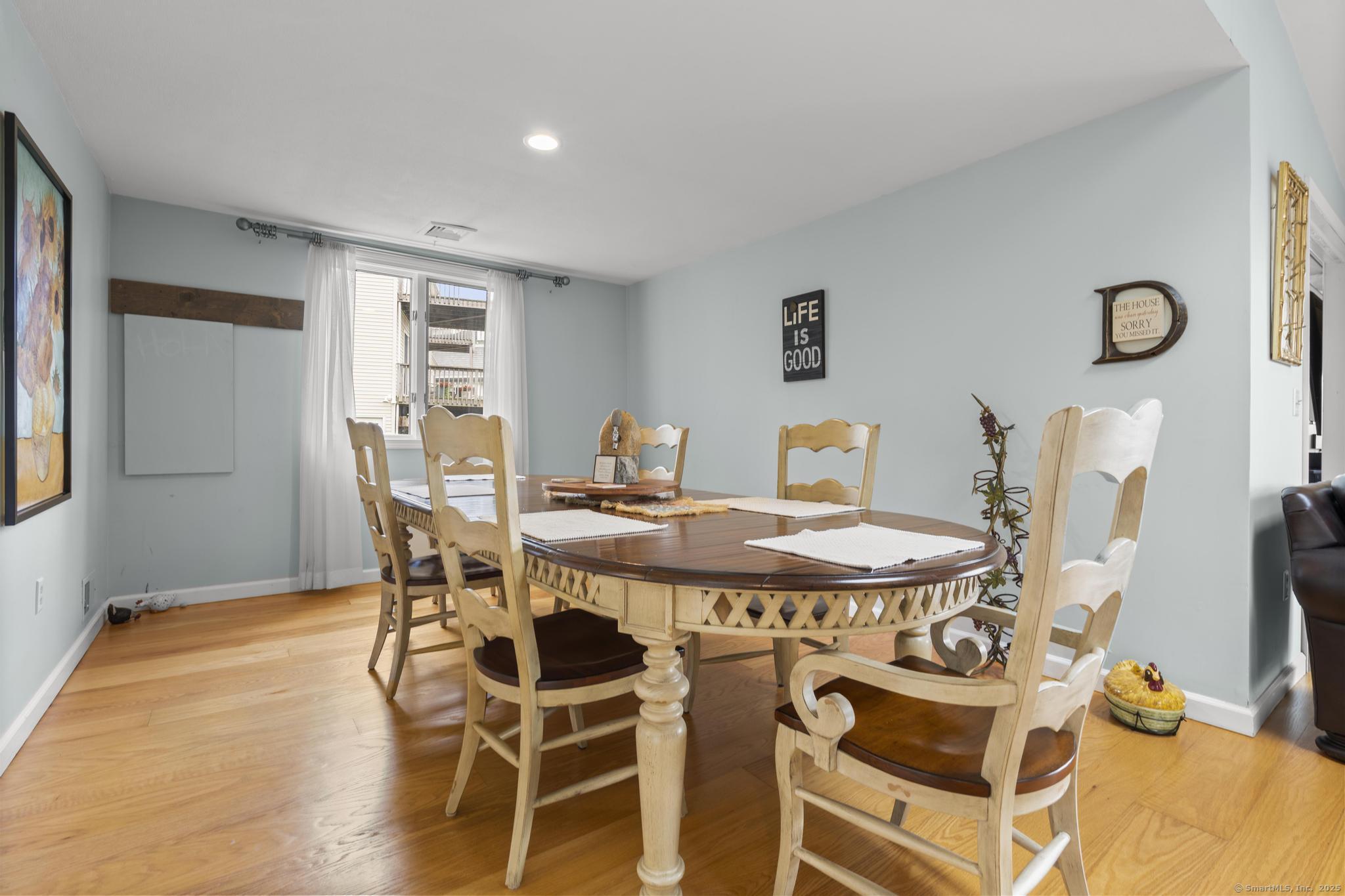 94 Summer Island Road Branford, CT 06405 - Photo 14 of 40 a view of a dining room with furniture and wooden floor