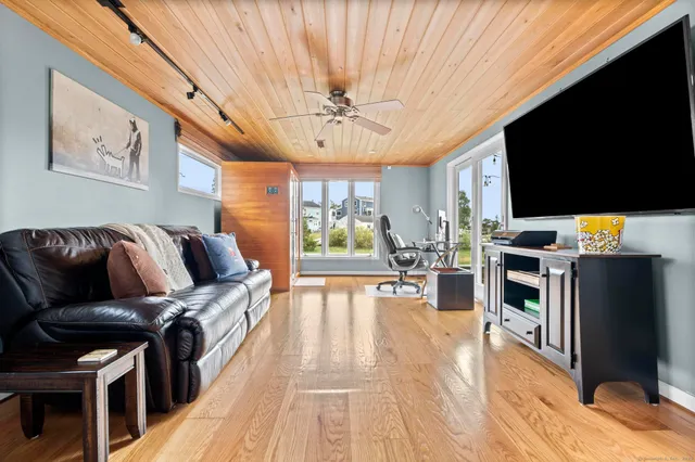a living room with furniture fireplace and flat screen tv