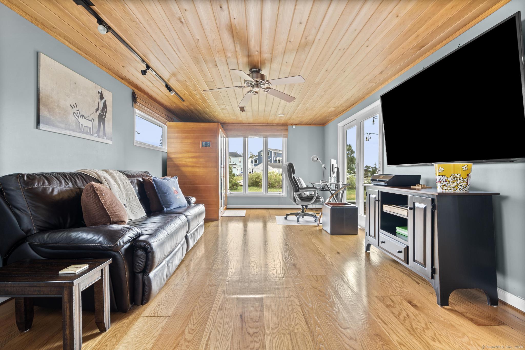 94 Summer Island Road Branford, CT 06405 - Photo 16 of 40 a living room with furniture fireplace and flat screen tv