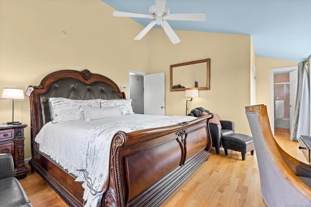 a bedroom with a bed a couch and dresser