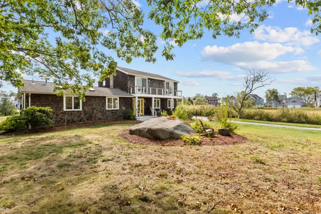 a view of a house with pool and a yard