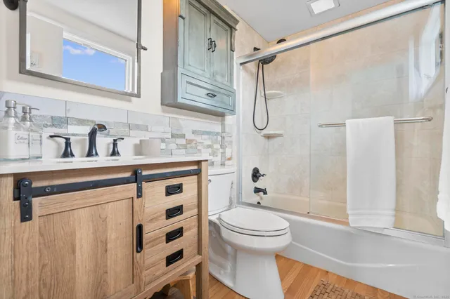 a bathroom with a sink a toilet and shower