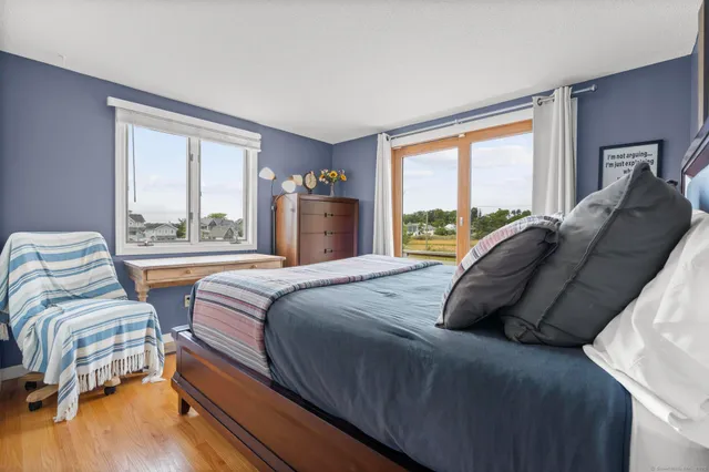 a bedroom with two beds and a large window