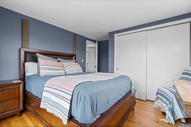 a bedroom with a bed and a mirror