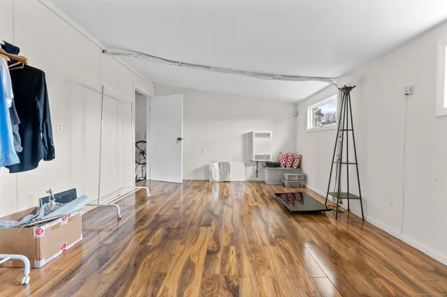 a very nice looking room with a large bed and a flat tv screen on the dresser