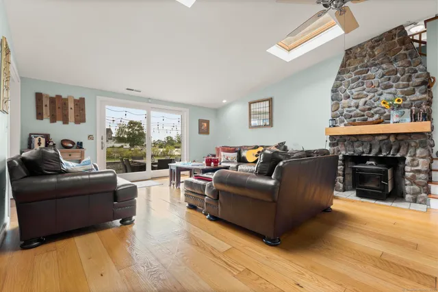 a living room with furniture a fireplace and a flat screen tv