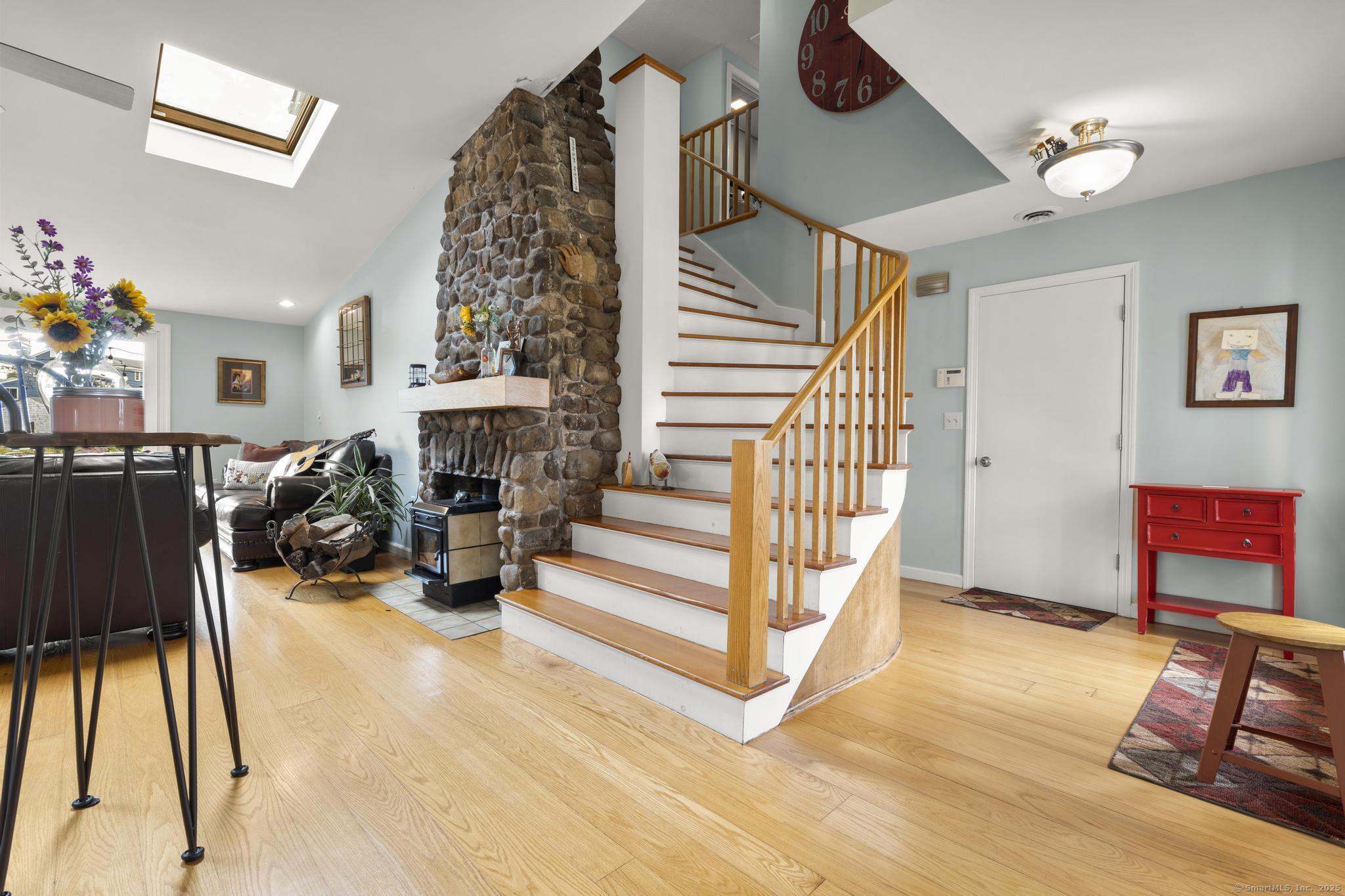 94 Summer Island Road Branford, CT 06405 - Photo 7 of 40 a view of a livingroom with furniture and a fireplace