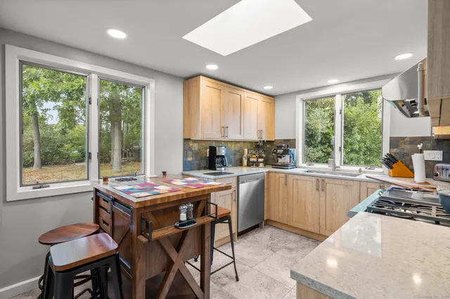 a kitchen with a stove a sink and a refrigerator