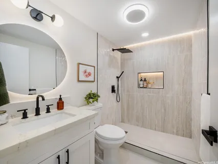 a bathroom with a sink toilet and shower