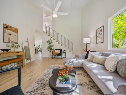 a living room with furniture and a wooden floor