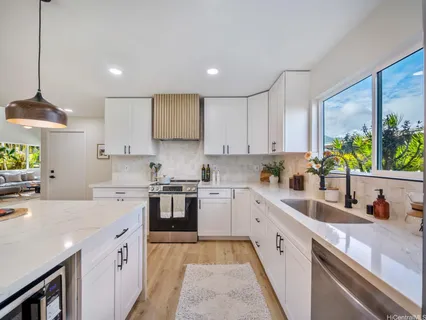 a kitchen with a sink stove and cabinets