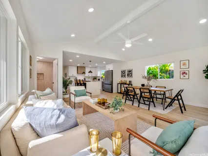 a living room with furniture kitchen and a table