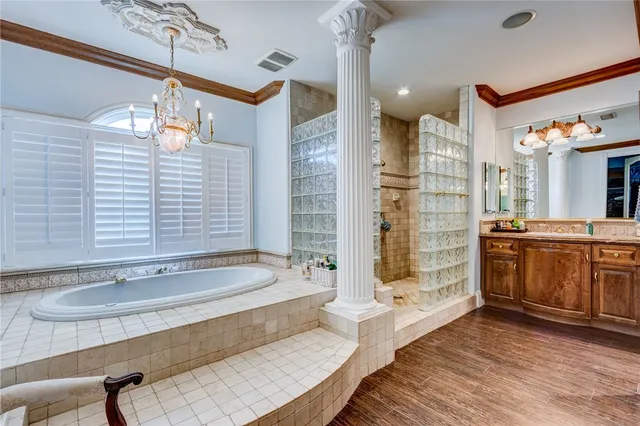 a bathroom with a tub a sink and a shower