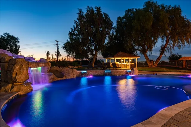 a view of a swimming pool with an outdoor space and seating area