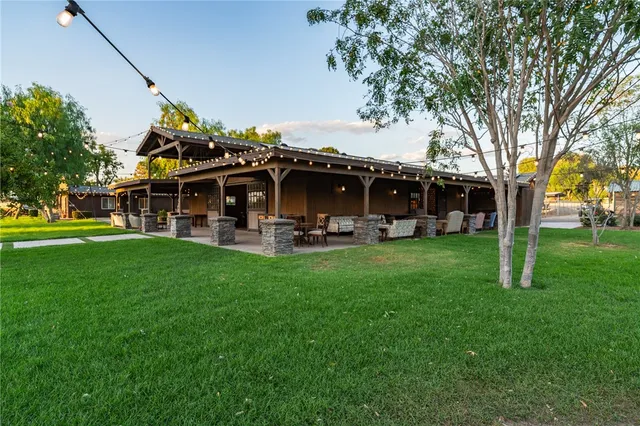 a front view of a building with a garden