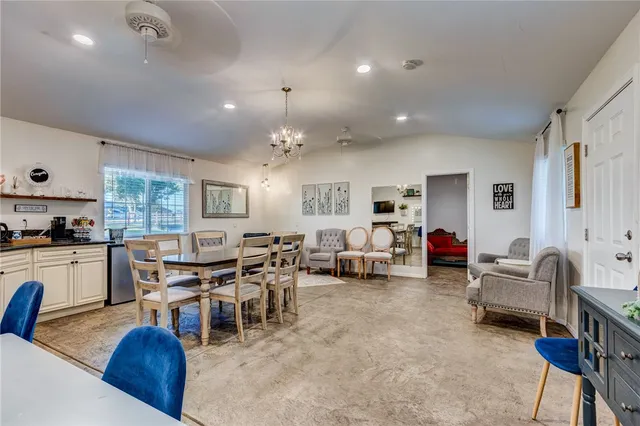 a living room with lots of furniture and kitchen view