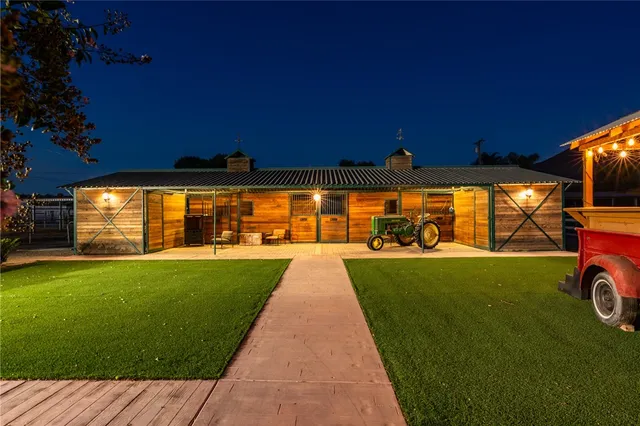 a view of a street with a big yard and a large tree