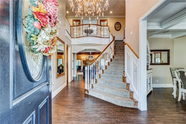 a view of entryway and hall with wooden floor