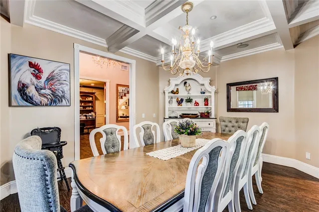 a view of a dining room with furniture and chandelier