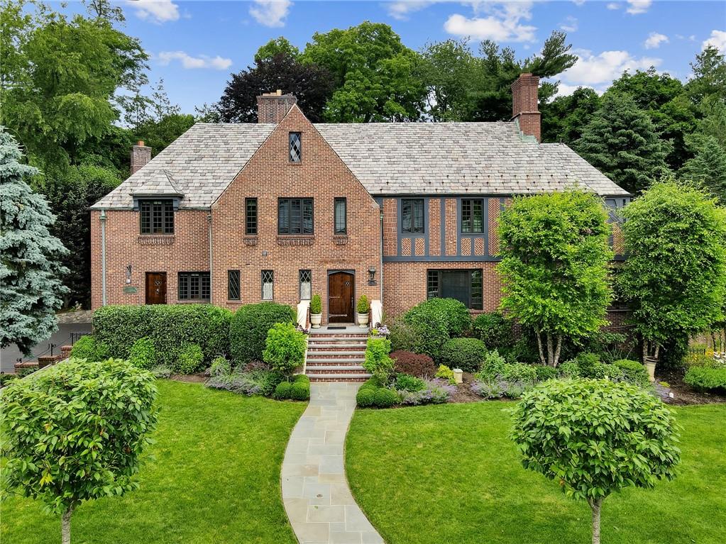 a aerial view of a house next to a big yard and large trees