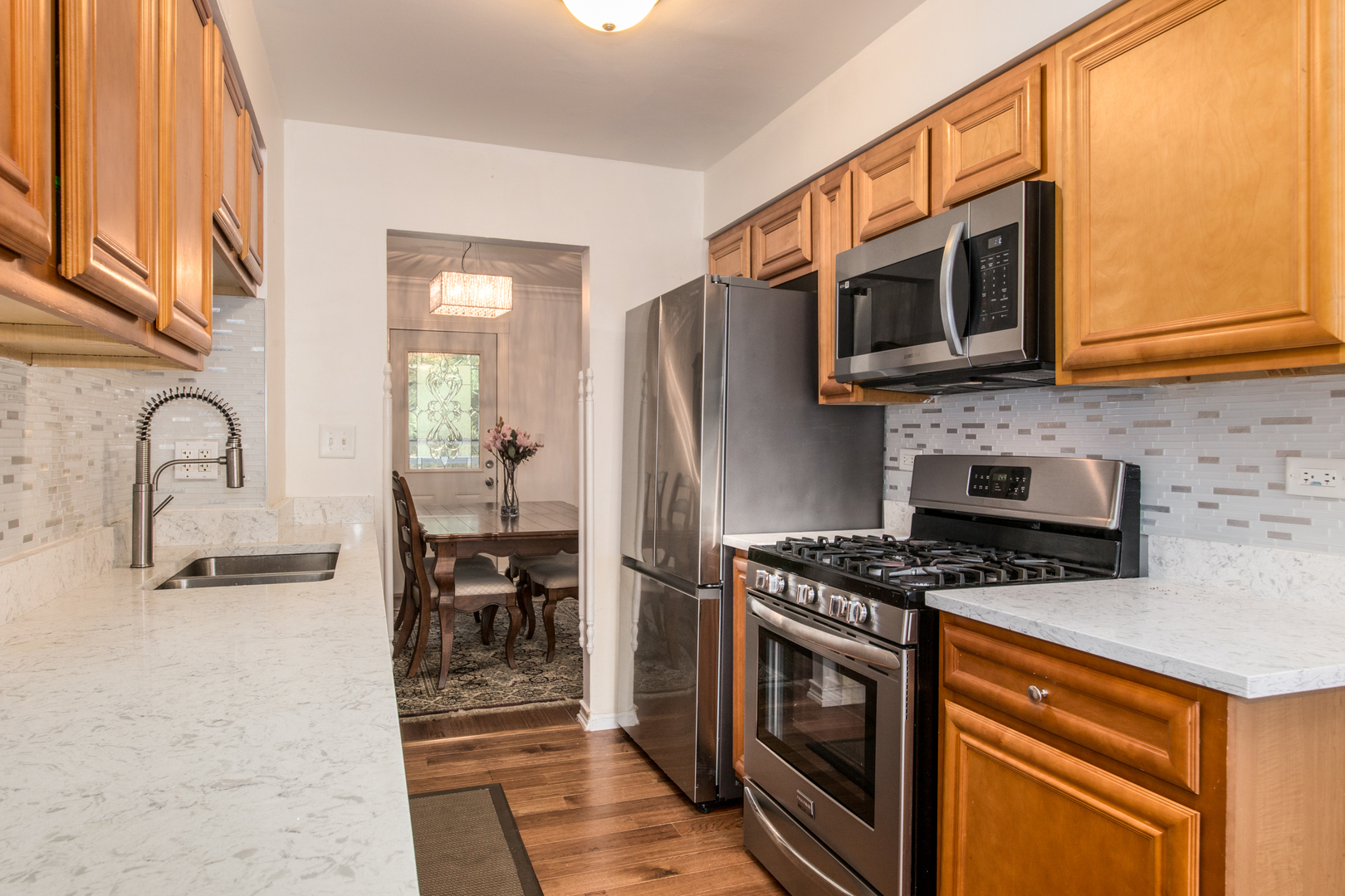 817 Hibbard Road, Unit D Wilmette, IL 60091 - Photo 15 of 26 a kitchen with stainless steel appliances granite countertop a stove microwave and sink