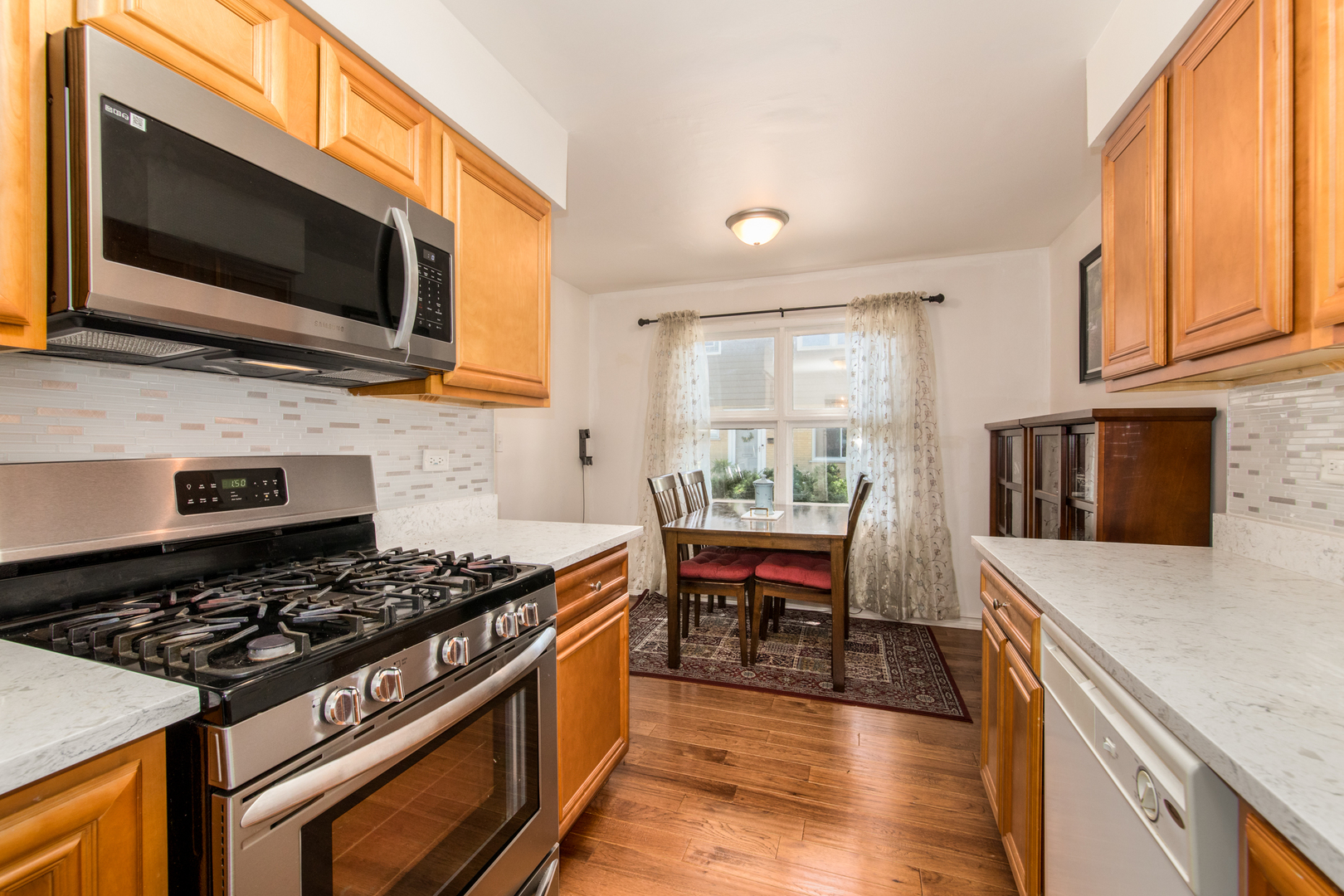 817 Hibbard Road, Unit D Wilmette, IL 60091 - Photo 16 of 26 a kitchen with stainless steel appliances a stove a sink and a microwave