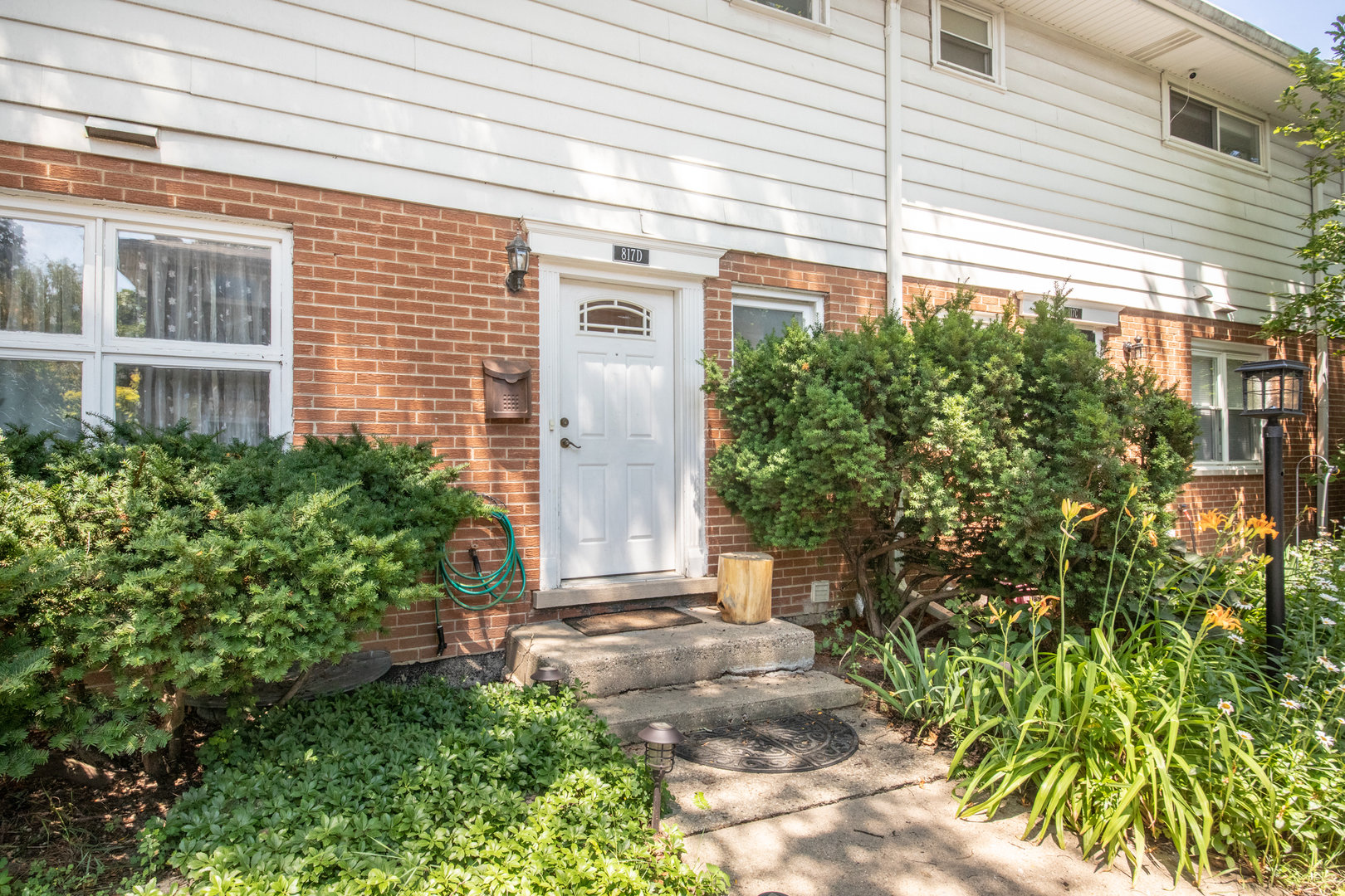 817 Hibbard Road, Unit D Wilmette, IL 60091 - Photo 2 of 26 a front view of a house with a yard
