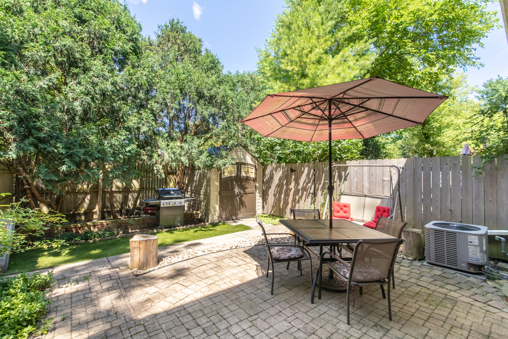 817 Hibbard Road, Unit D Wilmette, IL 60091 - Photo 24 of 26 a view of a patio with table and chairs under an umbrella