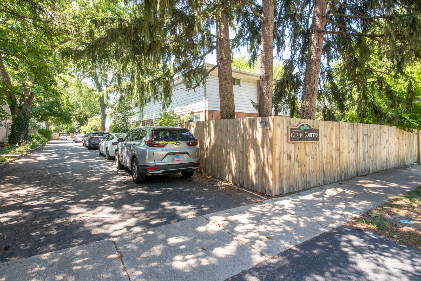 817 Hibbard Road, Unit D Wilmette, IL 60091 - Photo 3 of 26 a view of a yard with large trees