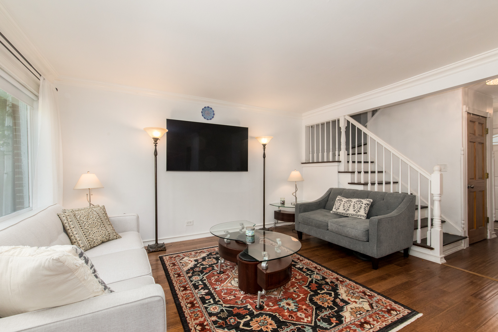 817 Hibbard Road, Unit D Wilmette, IL 60091 - Photo 6 of 26 a living room with furniture and a flat screen tv