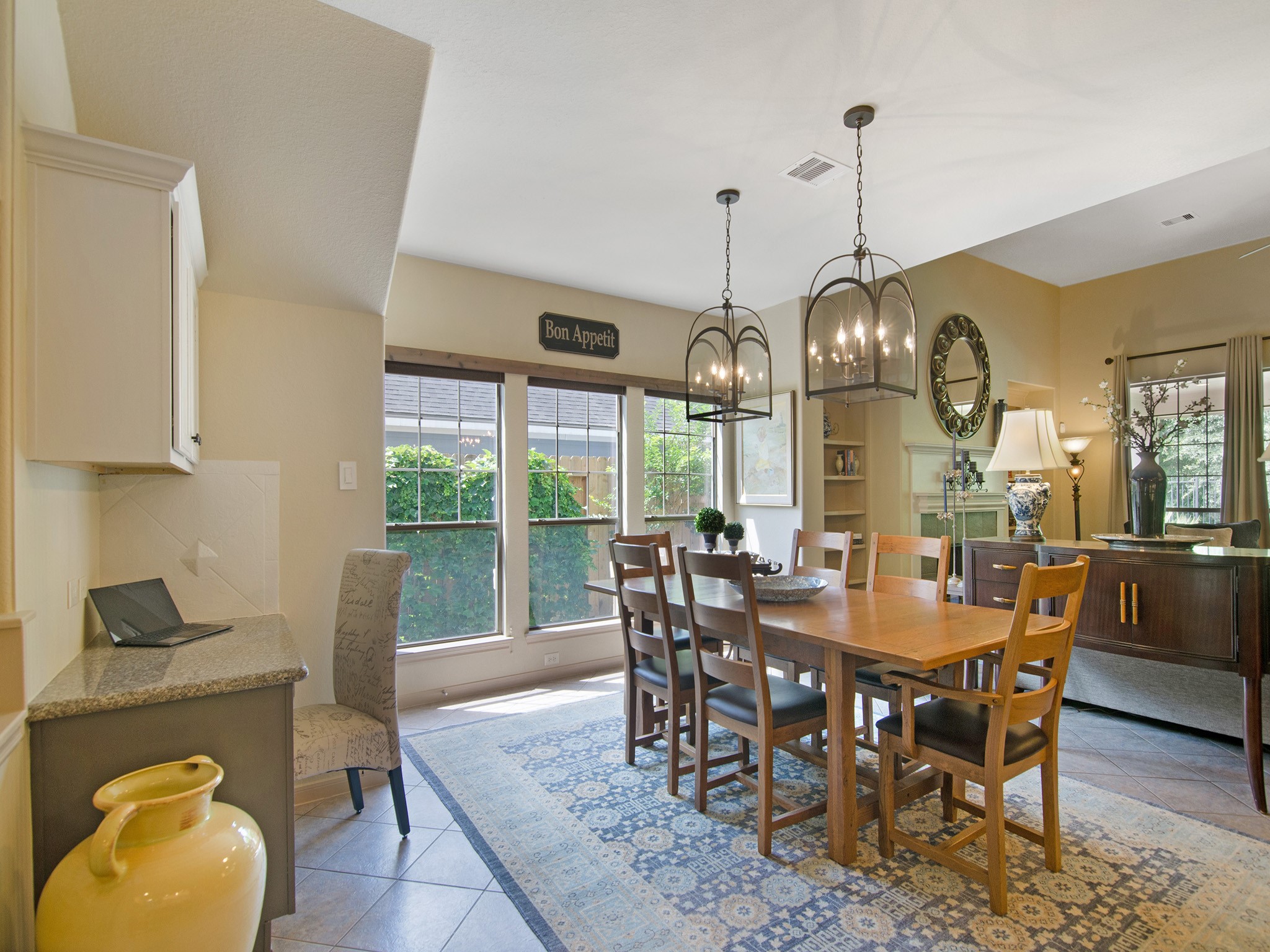 28323 Ryans Ridge Lane Spring, TX 77386 - Photo 15 of 45 A wall of windows fills the dining space with natural light while the built-in desk and cabinetry provide a convenient space for household organization, homework or a home command center.