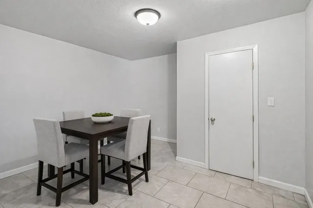a bedroom with a bed and a flat tv screen on dresser
