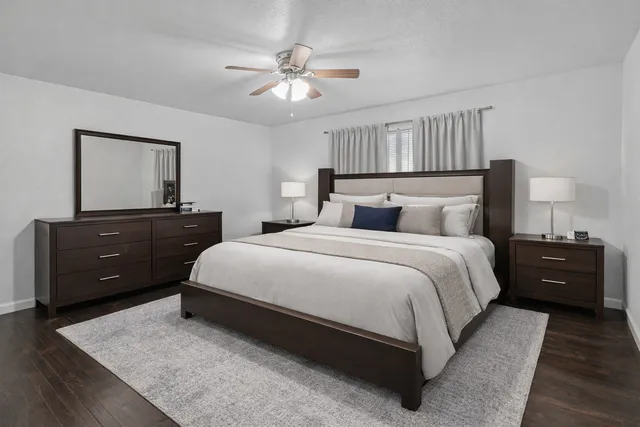 a bedroom with a bed and a chandelier